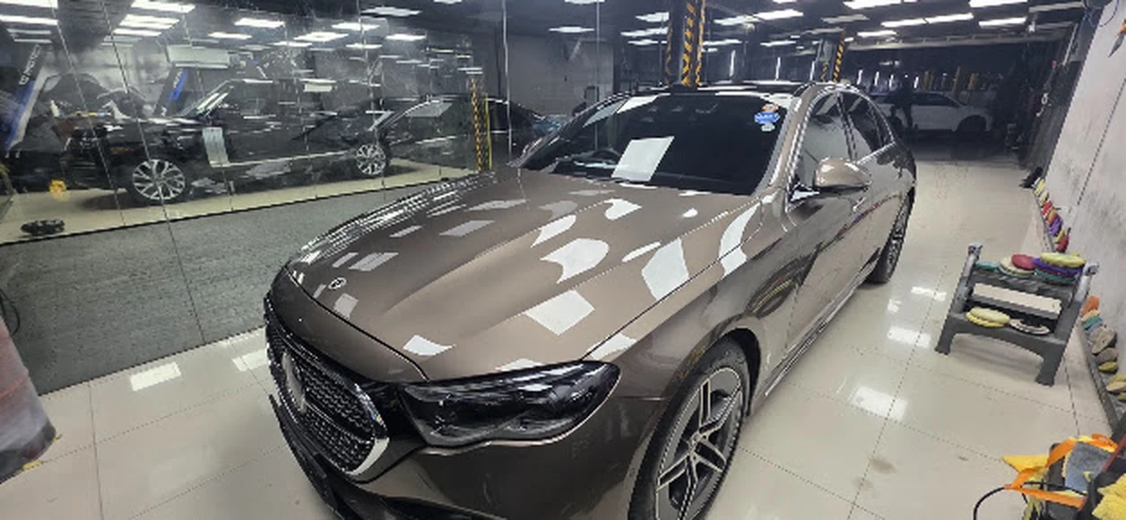 Mercedes-Benz E-Class with mirror-gloss clearcoat reflection inside RestorFX Sri Lanka workshop bay